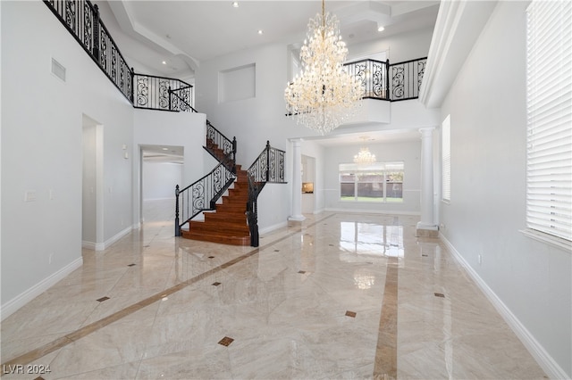 foyer entrance featuring a high ceiling and decorative columns