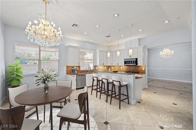 dining room with sink and a notable chandelier