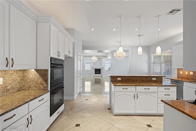 kitchen featuring white cabinetry, dark stone counters, and pendant lighting