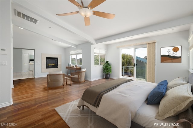 bedroom featuring dark hardwood / wood-style flooring, multiple windows, vaulted ceiling with beams, and access to exterior