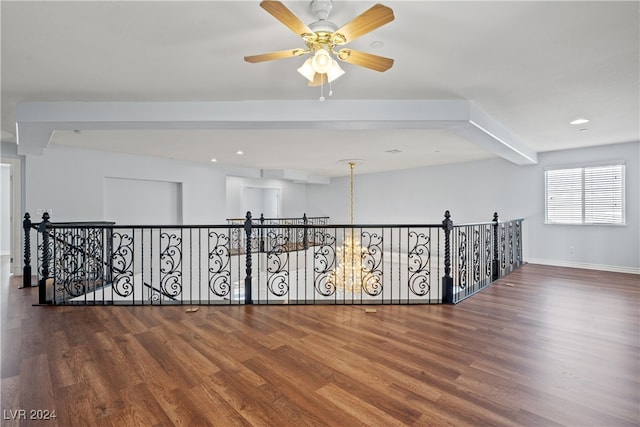 corridor with hardwood / wood-style floors and a notable chandelier