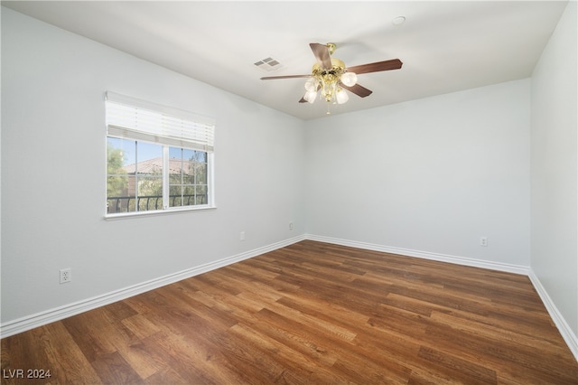 spare room with dark wood-type flooring and ceiling fan