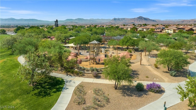 surrounding community featuring a mountain view and a playground