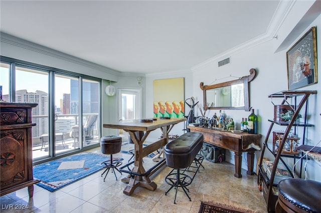 tiled dining room featuring ornamental molding