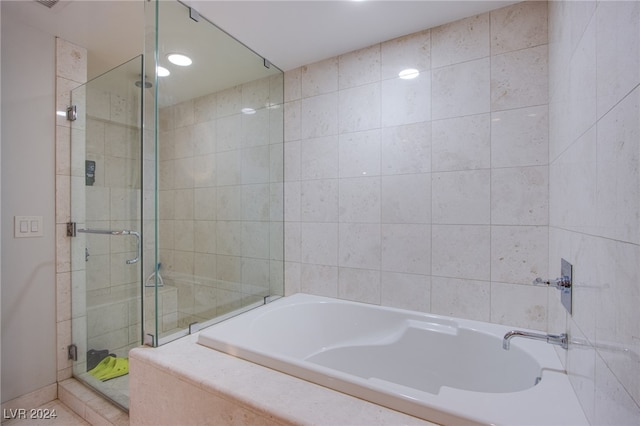 bathroom with separate shower and tub