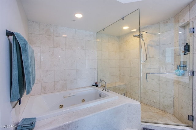 bathroom featuring independent shower and bath, tile walls, and tile patterned floors