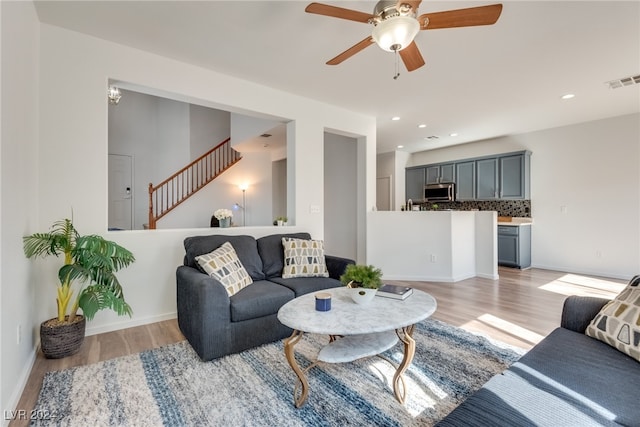 living room with ceiling fan and light hardwood / wood-style floors