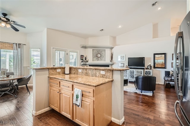 kitchen featuring lofted ceiling, light brown cabinets, ceiling fan, and dark wood-type flooring