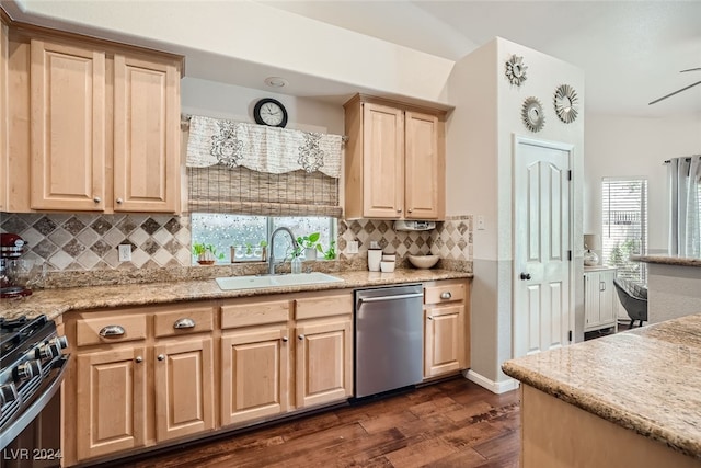 kitchen with a healthy amount of sunlight, sink, stainless steel appliances, and tasteful backsplash