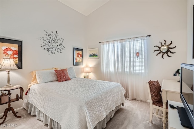 bedroom featuring lofted ceiling and carpet flooring