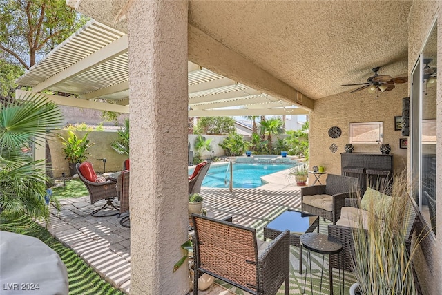 view of patio featuring ceiling fan and a fenced in pool