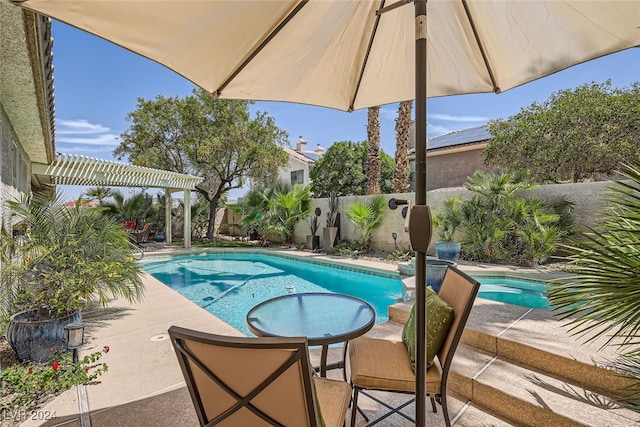 view of swimming pool featuring a patio and a pergola