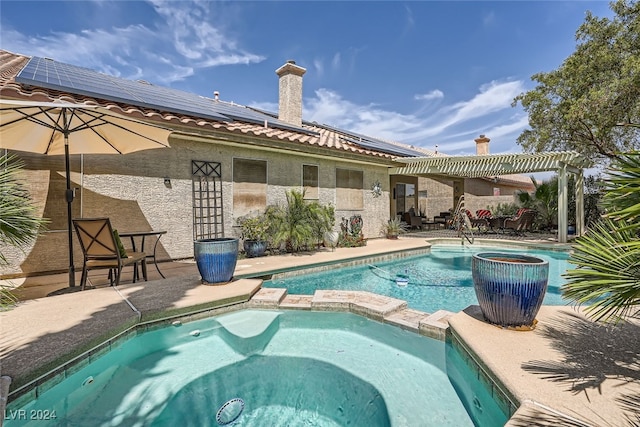 view of pool featuring a pergola, an in ground hot tub, and a patio area