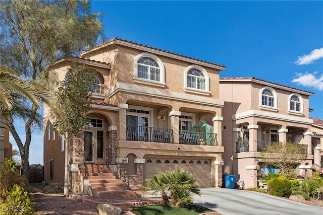 mediterranean / spanish-style house with a balcony and a garage