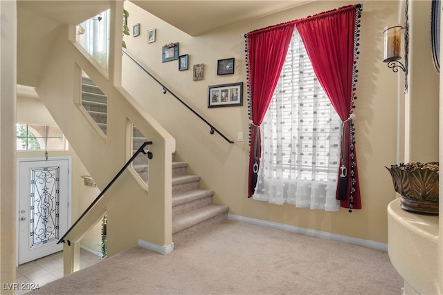 staircase featuring carpet flooring