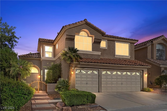 mediterranean / spanish-style house with a garage