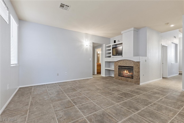 unfurnished living room with tile patterned floors and a healthy amount of sunlight