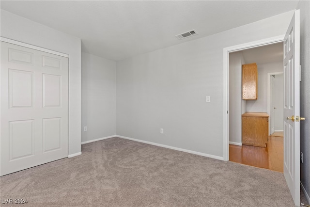 unfurnished bedroom featuring light colored carpet