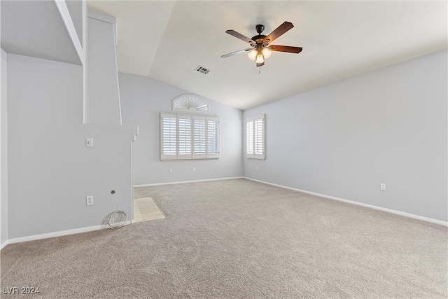 empty room with ceiling fan, carpet floors, and lofted ceiling