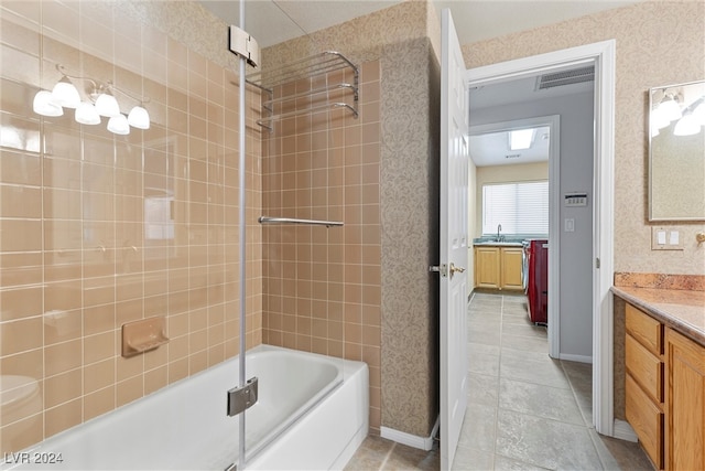 bathroom featuring tiled shower / bath combo and vanity