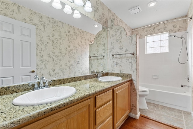 full bathroom with hardwood / wood-style floors, vanity, toilet, and shower / bath combination