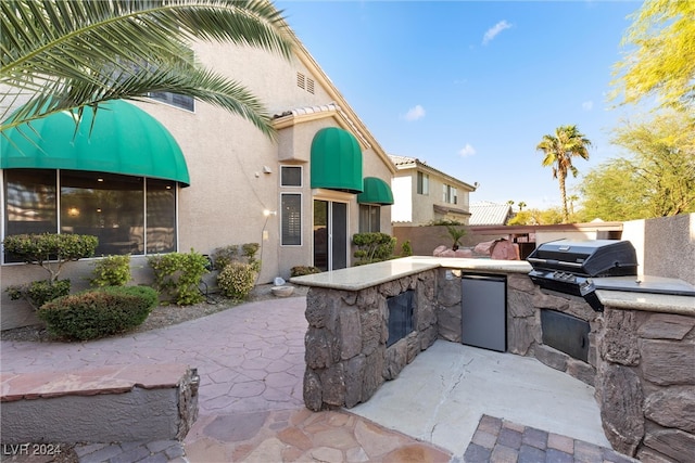 view of patio with area for grilling and an outdoor kitchen