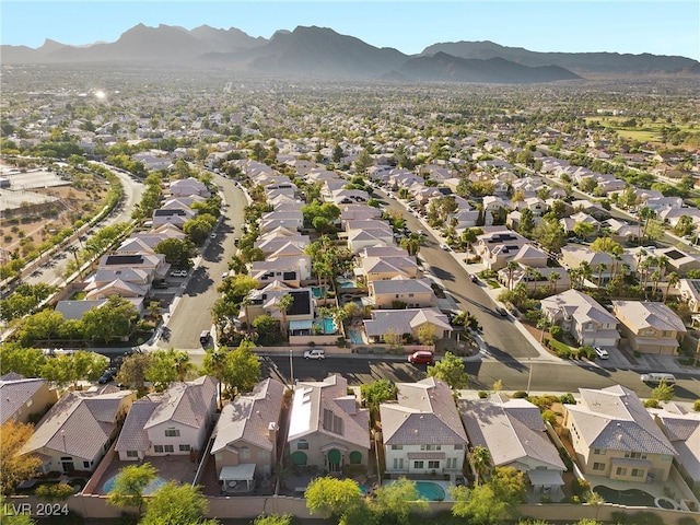 birds eye view of property with a mountain view