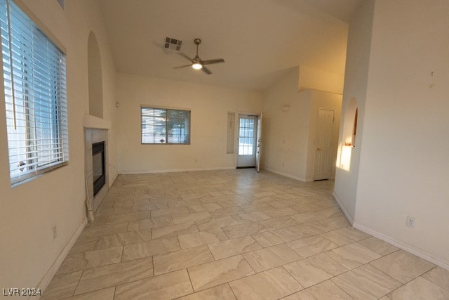 unfurnished living room featuring a high ceiling and ceiling fan