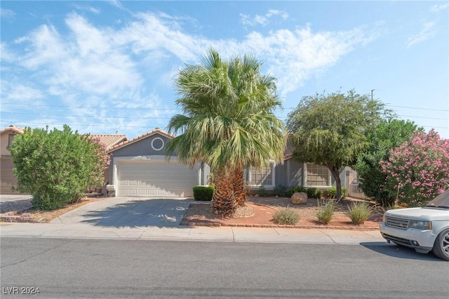 obstructed view of property with a garage