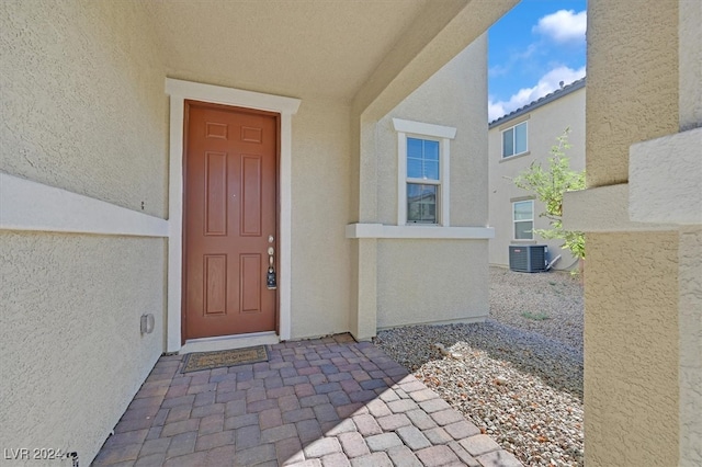 property entrance featuring central AC unit