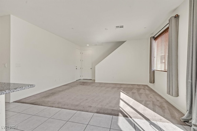 spare room with light colored carpet