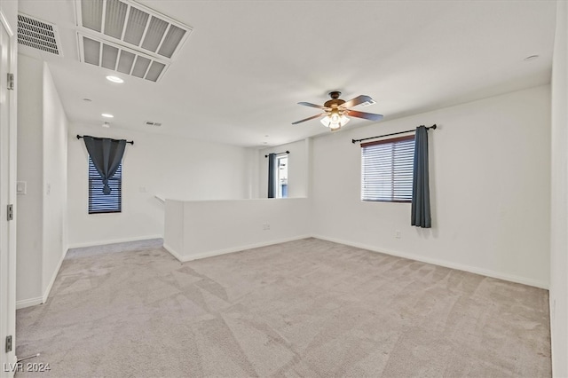 empty room with light colored carpet and ceiling fan