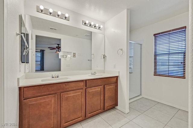 bathroom with tile patterned floors, ceiling fan, a shower with door, and vanity