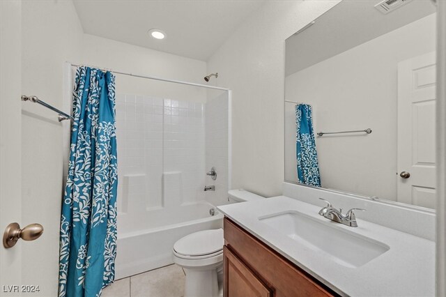 full bathroom featuring tile patterned floors, shower / tub combo with curtain, vanity, and toilet