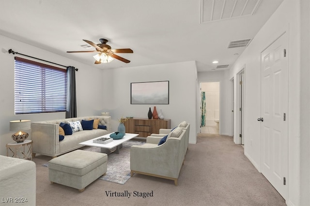 carpeted living room featuring ceiling fan