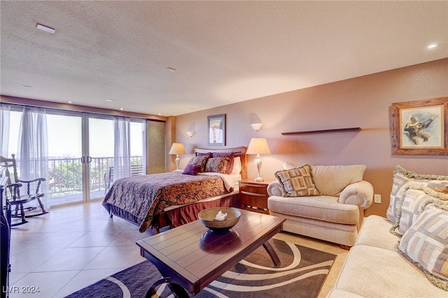 bedroom with light tile patterned floors, a textured ceiling, and access to exterior