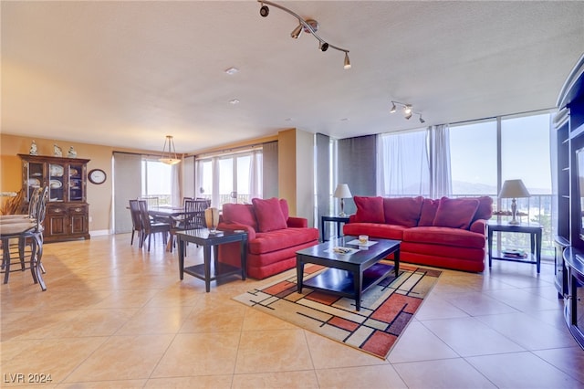 tiled living room featuring a textured ceiling