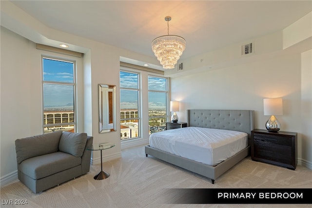 bedroom featuring a water view, light carpet, and a notable chandelier