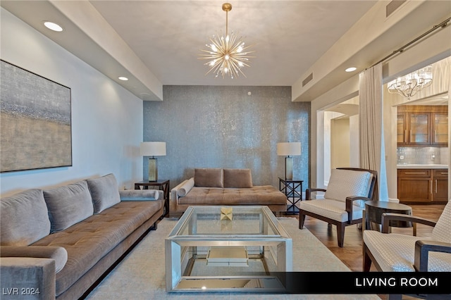 living room featuring a chandelier and light hardwood / wood-style floors