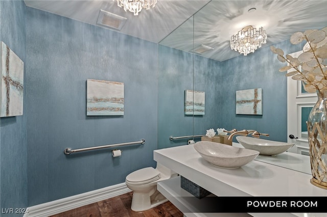 bathroom with wood-type flooring, toilet, and sink