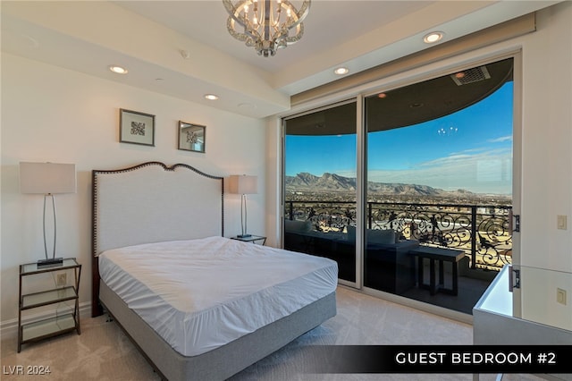 carpeted bedroom with access to outside and a chandelier