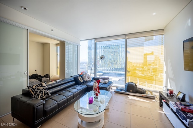 tiled living room featuring a wall of windows