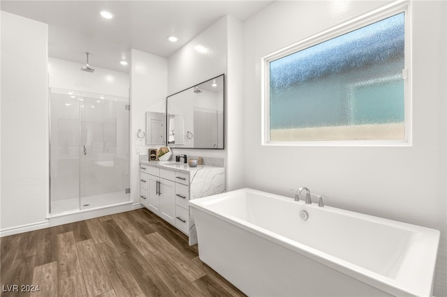 bathroom featuring wood-type flooring, vanity, and separate shower and tub