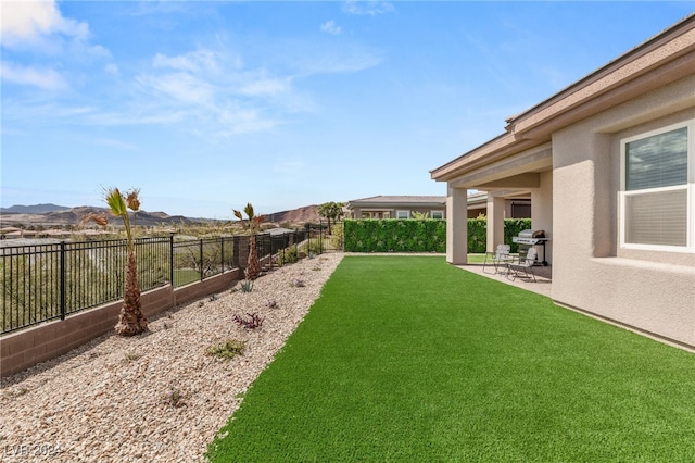 view of yard featuring a mountain view and a patio area