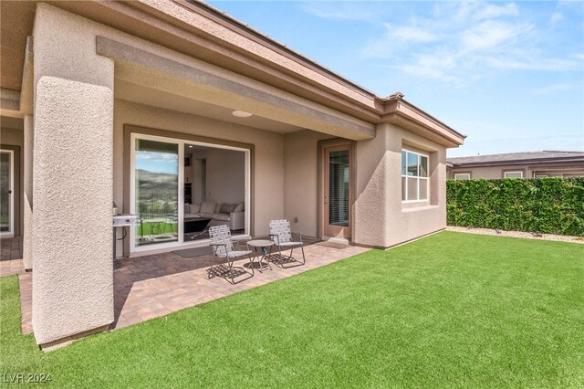 rear view of property with a patio area and a yard