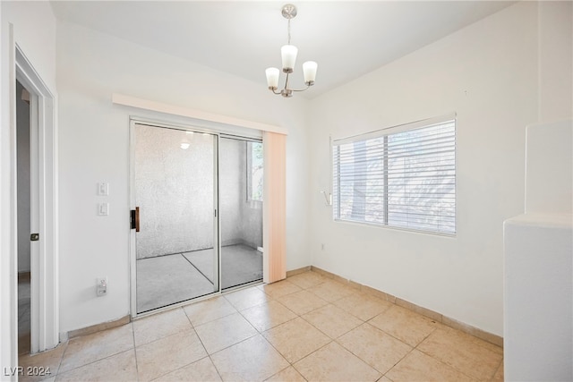 unfurnished bedroom featuring a notable chandelier, light tile patterned flooring, and a closet