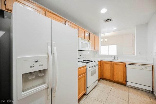 kitchen featuring white appliances, sink, and light tile patterned floors