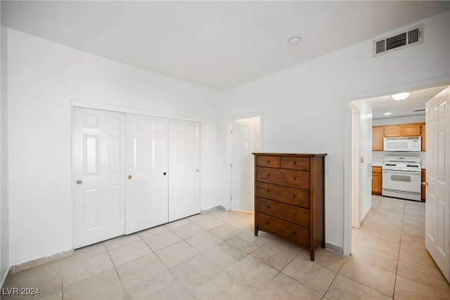 bedroom with a closet and light tile patterned floors