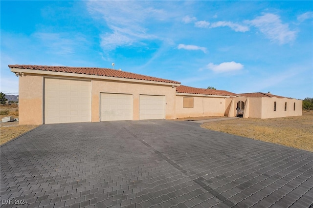 mediterranean / spanish house featuring a front yard and a garage