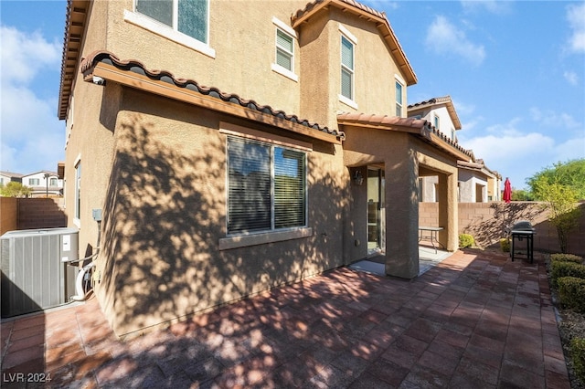 back of property featuring a patio and central air condition unit